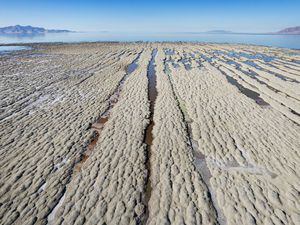 (Francisco Kjolseth | The Salt Lake Tribune) The Great Salt Lake ever-growing exposed lakebed bakes in the sun during ongoing drought conditions on Tuesday, Oct. 18, 2022. Scientists monitoring the lake's food web said its ecological collapse has begun as the lake continues to hit record-low elevations and dangerous salinity levels by the day.
