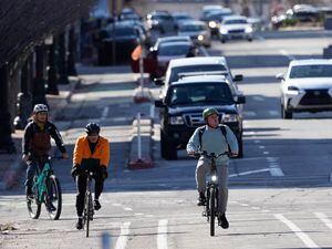 (Francisco Kjolseth | The Salt Lake Tribune) Cyclists use the designated bike lanes along 300 South in downtown Salt Lake City on Thursday, March 16, 2023. 