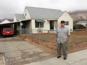 (Courtesy USDA Rural Development Utah) Jerry Heer stands in front of his Carbon County home in 2014. USDA grants helped pay for repairs to his roof and windows.