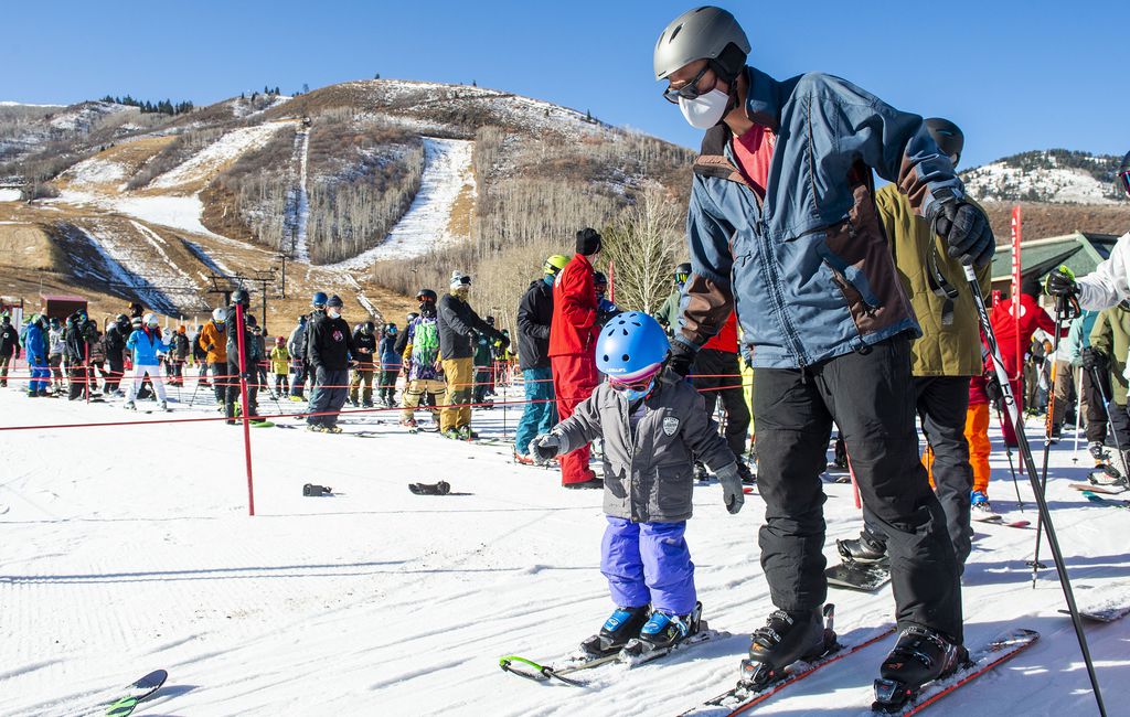 (Rick Egan | The Salt Lake Tribune) Zac Beveridge skis with 3-year-old Finley on opening day at Park City last November.