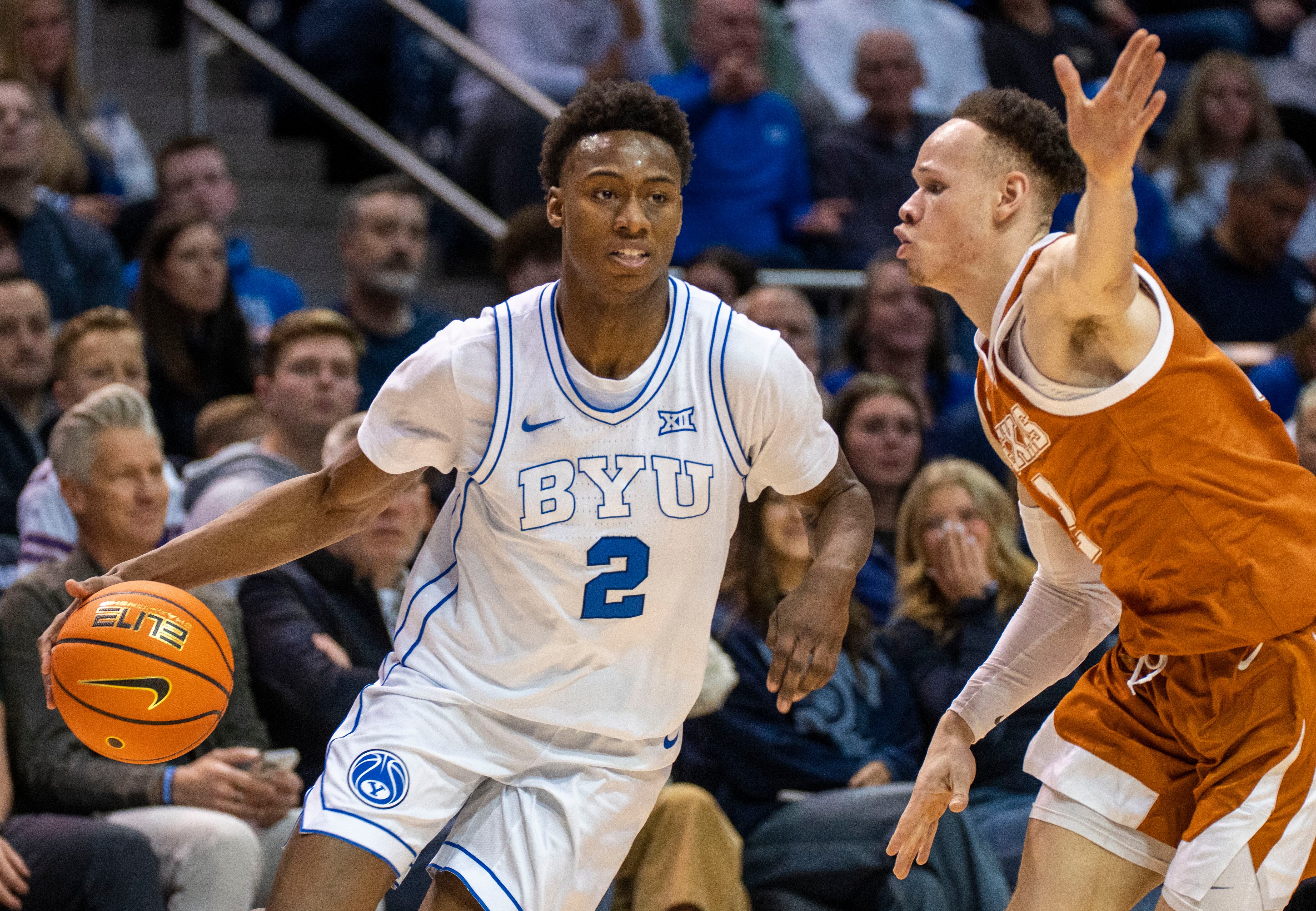 (Rick Egan | The Salt Lake Tribune) Brigham Young Cougars guard Jaxson Robinson (2) is guarded by Texas Longhorns guard Chendall Weaver (2), in basketball action between the Brigham Young Cougars and the Texas Longhorns, at the Marriott Center, on Saturday, Jan. 27, 2024.
