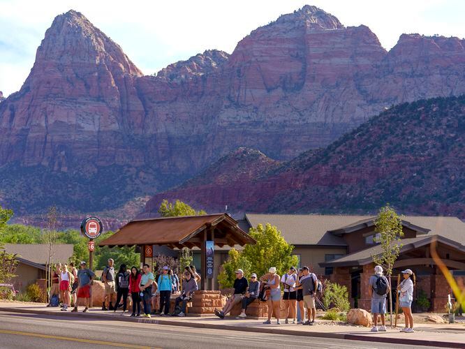(Leah Hogsten | The Salt Lake Tribune) Mornings in Springdale, just outside the entrance to Zion National Park are a flurry of activity as hikers rush to board city shuttles to take them into the park, Sept. 26, 2021. Springdale, population 529, sees about 16,000 tourists a day. 