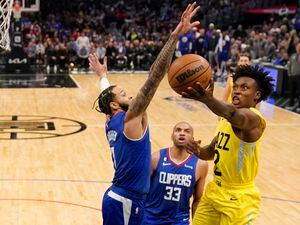 Utah Jazz guard Collin Sexton, right, shoots as Los Angeles Clippers guard Amir Coffey, left, defends and forward Nicolas Batum watches during the second half of an NBA basketball game Monday, Nov. 21, 2022, in Los Angeles. (AP Photo/Mark J. Terrill)