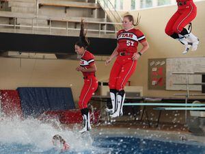 (University of Utah Athletics) Members of the Utah Utes softball team jump into the swimming and diving pool on campus after a win. Jumping in the pool is a tradition that dates back to 1991.