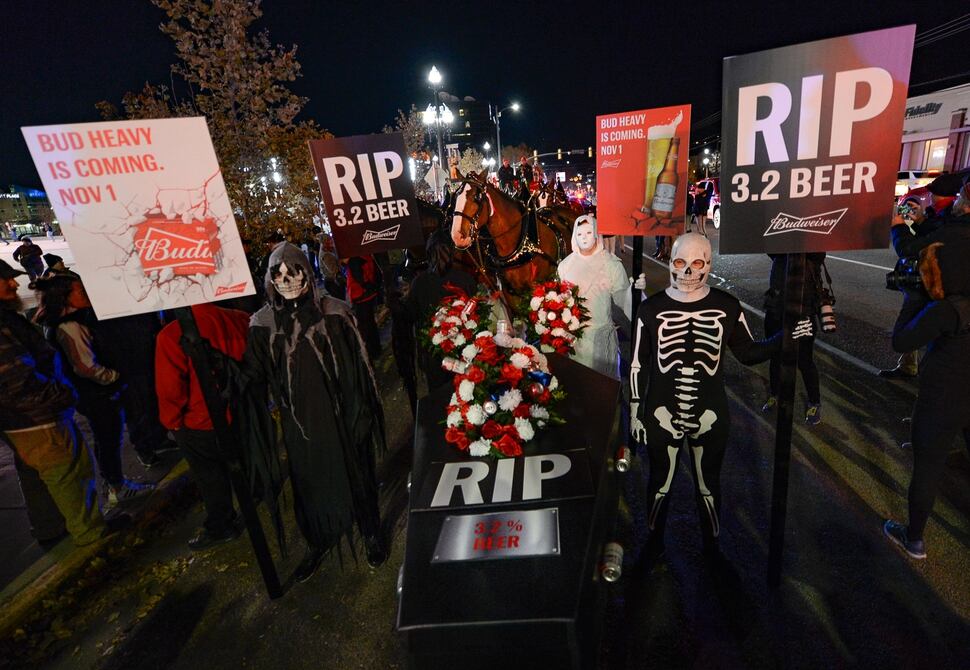 (Francisco Kjolseth | The Salt Lake Tribune) Budweiser’s iconic Clydesdales make a special trip to Utah to celebrate the changing beer laws in the state, joined by a “ghoulish group of pallbearers,” on Wed. Oct. 30, 2019, for a funeral procession for Utah’s last remaining 3.2 percent beer, on their way to Bar X, Beer Bar and Johnny’s on 200 South in Salt Lake City, as the state prepares to start selling 5 percent alcohol-by-volume in grocery and convenience stores starting Friday.
