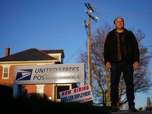 (Carolyn Kaster | AP) Gerald Groff, a former postal worker whose case was argued before the Supreme Court, stands during a television interview near a "Now Hiring" sign posted at the roadside at the U.S. Postal Service, Wednesday, March 8, 2023, in Quarryville, Pa.