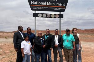 (Photo courtesy of the Bears Ears Inter-Tribal Coalition) Tribal and federal officials met last week at White Mesa, Utah, to sign an historic cooperative agreement for the management of Bears Ears National Monument. Flanked by Undersecretary of Agriculture Homer Wilkes, left, and BLM Director Tracy Stone-Manning, right, members of the Bears Ears Commission gathered at the newly unveiled monument sign on State Road 261. Pictured left to right are Commissioners Christopher Tabbee and son (Ute), Malcolm Lehi (Ute Mountain Ute), Carleton Bowekaty (Zuni Pueblo), Timothy Nuvangyaoma (Hopi) and Davis Filfred (Navajo).