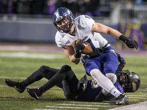 Weber State tight end Andrew Vollert (87) gets brought down by James Madison cornerback Curtis Oliver (26) during the first half of an NCAA college football game in the quarterfinals of the FCS playoffs Friday, Dec. 8, 2017, in Harrisonburg, Va. (Daniel Lin/Daily News-Record via AP)
