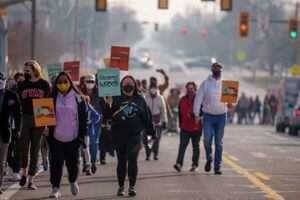 (Trent Nelson  |  The Salt Lake Tribune) People march down 1300 East celebrating the legacy of Martin Luther King Jr., in Salt Lake City on Monday, Jan. 17, 2022.