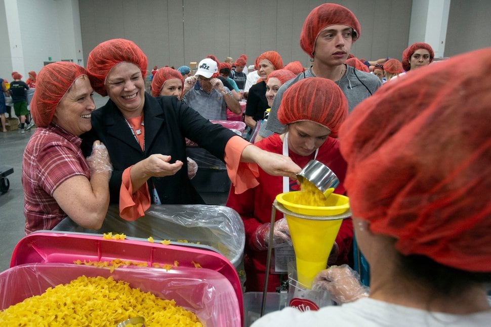  (Photo courtesy of The Church of Jesus Christ of Latter-day Saints) Sharon Eubank, president of Latter-day Saint Charities, helps volunteers fill bags with pasta during a service project at the 68th United Nations Civil Society Conference in Salt Lake City, Monday, Aug. 26, 2019.