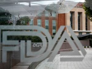 FILE - This Aug. 2, 2018, file photo shows the U.S. Food and Drug Administration building behind FDA logos at a bus stop on the agency's campus in Silver Spring, Md. The FDA on Monday, July 22, 2019, approved nine generic versions of Pfizer Inc.’s Lyrica. (AP Photo/Jacquelyn Martin, File)