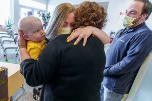 (Leah Hogsten | The Salt Lake Tribune) Alisha Keyworth, with her daughter Abigail Rose and and fiance, Nick Staten, hugs Dr. Janice Byrne a year after the first in-utero fetal surgery done in Utah that repaired Abigail's spina bifida repair at Primary Children's Eccles Outpatient Building, April 13, 2022. Doctors with the Utah Fetal Center performed the surgery on April 6, 2021.