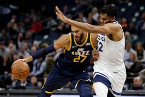 Utah Jazz center Rudy Gobert (27) drives on Minnesota Timberwolves center Karl-Anthony Towns (32) during the first quarter of an NBA basketball game Wednesday, Nov. 20, 2019, in Minneapolis. (AP Photo/Andy Clayton- King)