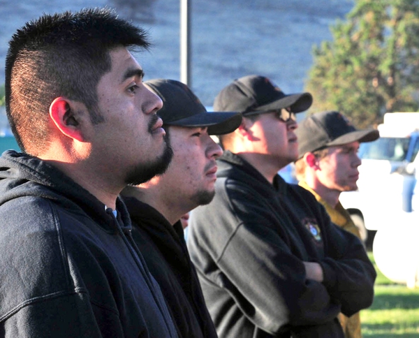 Members of the Warm Springs Hotshots stand at the ready in Warm Springs, Ore., July 1, 2018. Most Warm Springs Hotshots belong to one of the three Confederated Tribes of Warm Springs and live on the sparsely populated reservation about 100 miles southeast of Portland, Ore. (AP Photo/Tom James)
