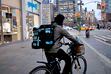 (Gabby Jones | The New York Times) A delivery rider, who is a gig worker, in New York, April 4, 2022. A Utah law that's meant to allow flexible workers — gig workers for app-based companies such as Uber — collect affordable benefits was enacted last year.