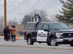 (Chris Samuels | The Salt Lake Tribune) Onlookers console one another as police investigate a fatal shooting near Hunter High School in West Valley City Thursday, Jan. 13, 2022.