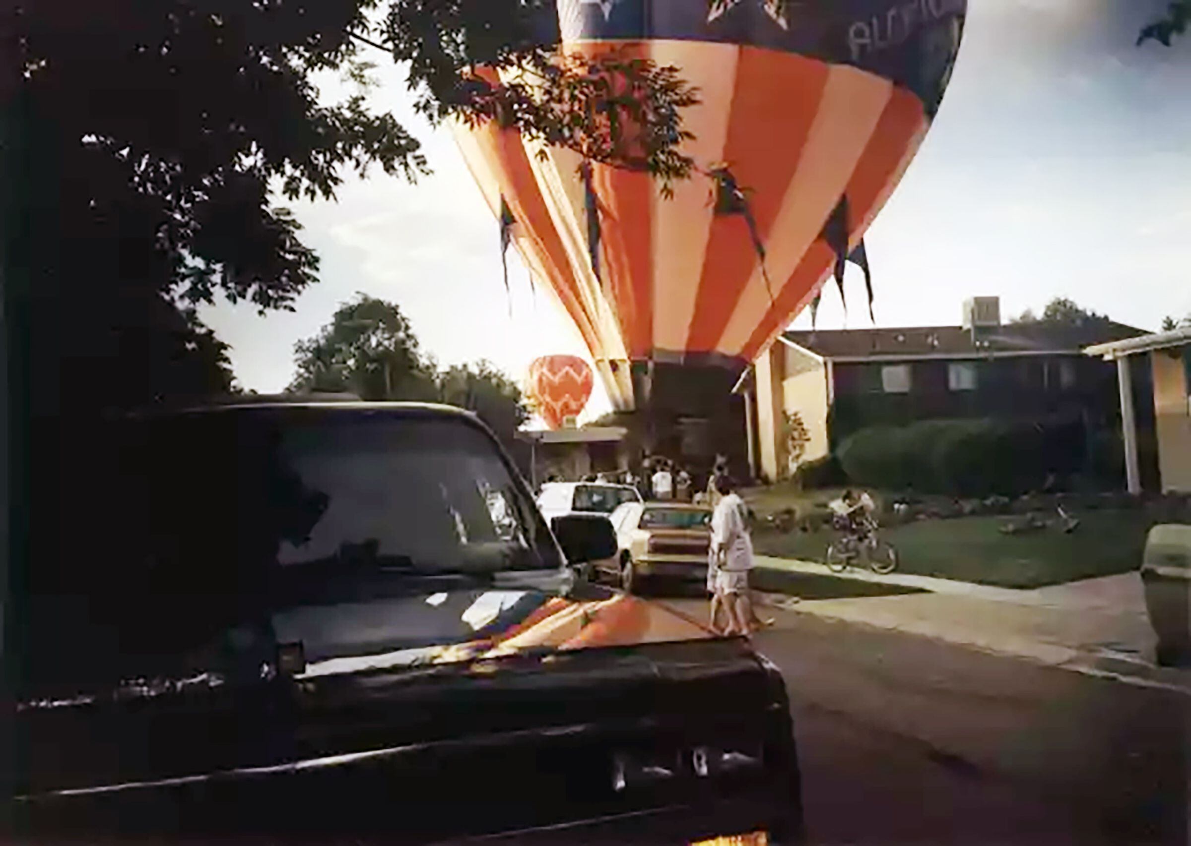 (Curt Bramble) A balloon carrying Guns N’ Roses frontman Axl Rose with Curt Bramble lands on a street in Cottonwood Heights in 1989. The balloon in the background carried Slash and other members of the band, according to Bramble.