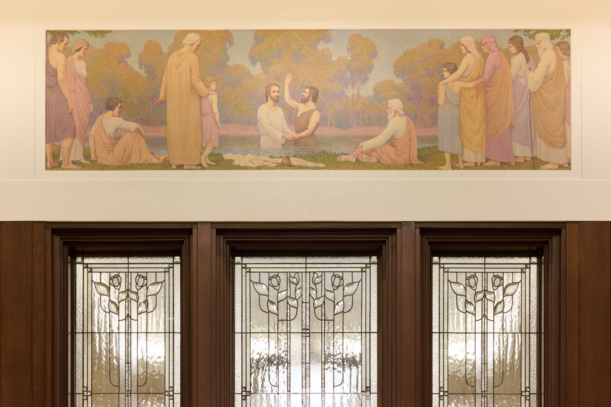 (The Church of Jesus Christ of Latter-day Saints) A mural above a window pane in the Layton Utah Temple. The mural shows the baptism of Jesus.