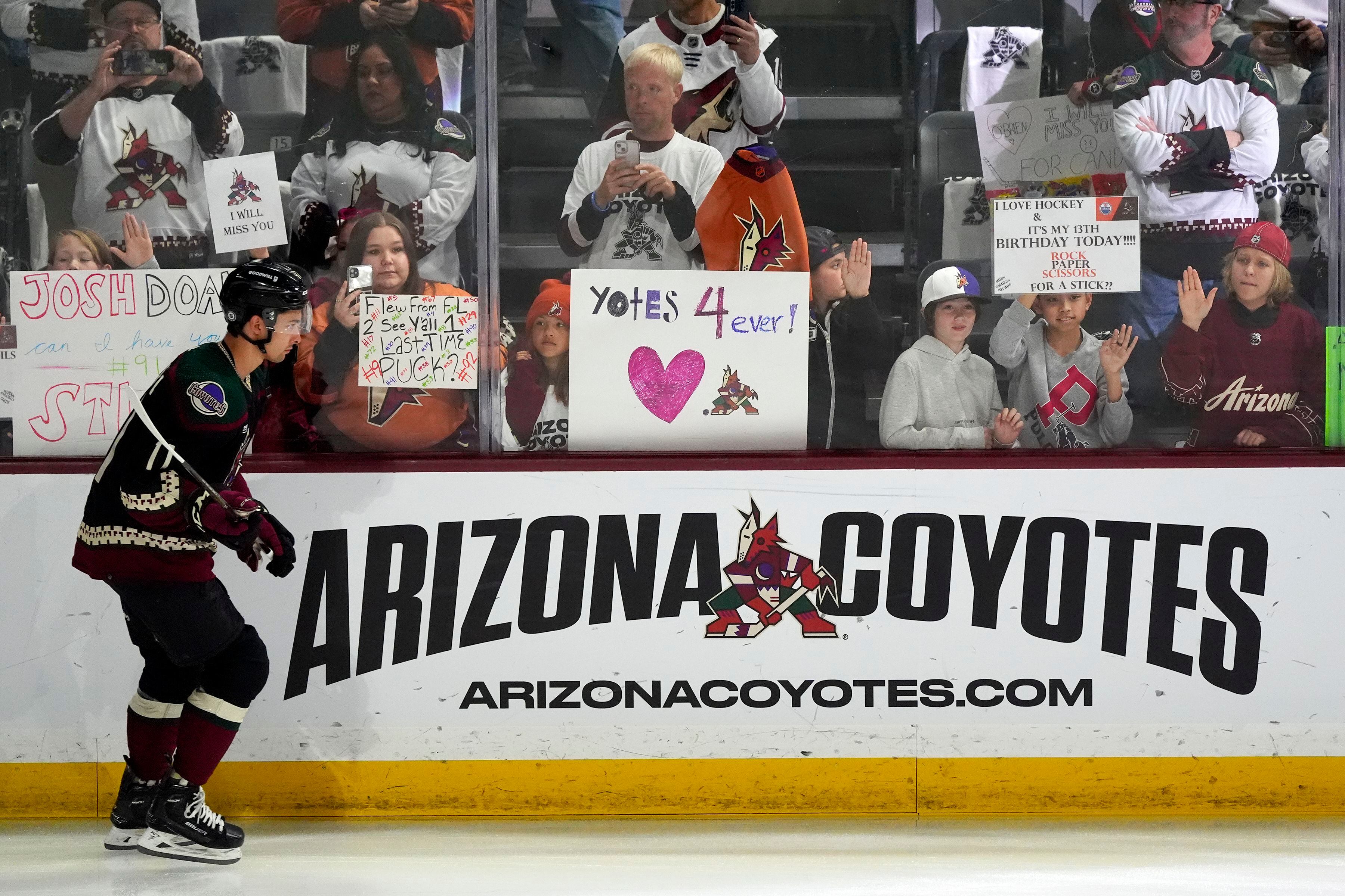 (Ross D. Franklin | AP) Arizona Coyotes' Dylan Guenther skates past fans as players warm up. The Coyotes are moving to Salt Lake City in a deal that could be signed less than 24 hours after the game. Hockey could return, perhaps within five years, but the stark reality is this is the end for the foreseeable future.