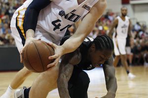 Utah Jazz's Isaac Haas, left, battles for the ball with Portland Trail Blazers' Archie Goodwin during the second half of an NBA summer league basketball game Saturday, July 7, 2018, in Las Vegas. (AP Photo/John Locher)