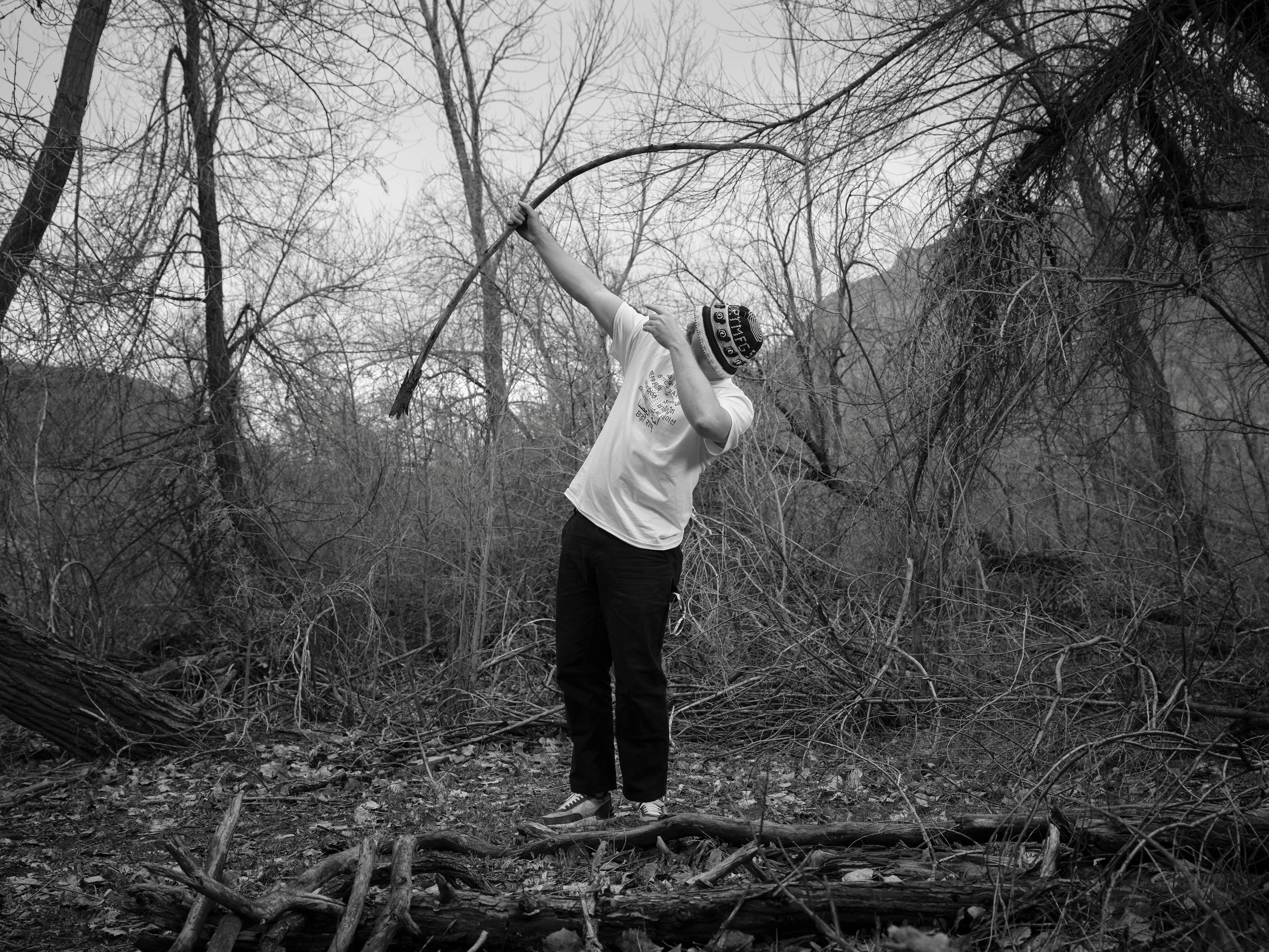 (Lindsay D'Addato | The New York Times) Logan Jugler, who with a friend found minor fame on Instagram by reviewing sticks, judges a stick for its bow-like properties in Ogden, Utah on March 30, 2024. What started as a wilderness jest has morphed into something slightly less tongue-in-cheek, for the act of finding, handling and appreciating a good stick seems to speak to one’s inner 5-year-old.