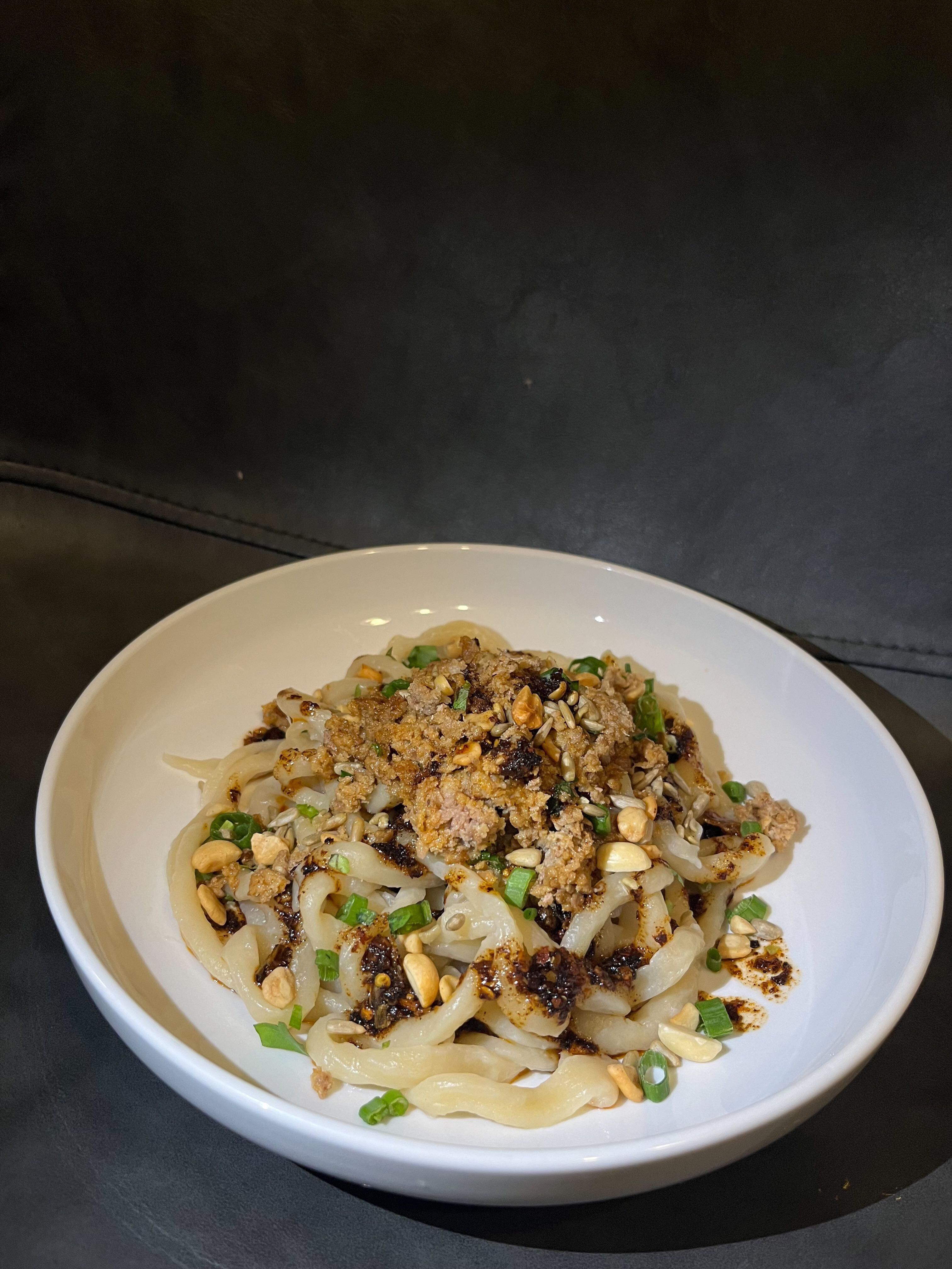 (Baylei Foster) Sweet water noodles with ground pork, housemade chili crisp, cilantro, garlic and onion greens from Sego are shown in this undated photo. The noodles are made with Redmond Real Salt and Central Milling Flour. The pork is from Roots Tech Farm. The veggies are from Red Acre Farm.