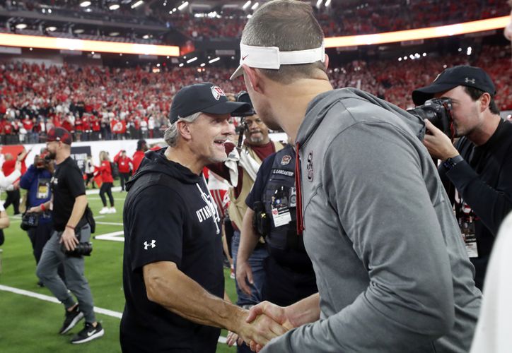 Utah coach Kyle Whittingham, left, shakes hands with Southern California coach Lincoln Riley after Utah's 47-24 victory in the Pac-12 Conference championship NCAA college football game Friday, Dec. 2, 2022, in Las Vegas. (AP Photo/Steve Marcus)