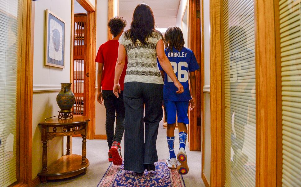 Leah Hogsten | The Salt Lake Tribune Brenda Mayes walks with her two sons, both referred to as Òchild doeÓ and Òstudent 2Ó in the lawsuit she filed, Tuesday, May 7, 2019 against the Davis School District, accusing a bus driver of racial discrimination against her son, left.