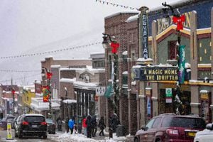 (Francisco Kjolseth | The Salt Lake Tribune) People visit historic Main Street in Park City on Thursday, Dec. 30, 2021, walking past the Egyptian Theatre — one of the major venues of the Sundance Film Festival. The theater will again sit dark during Sundance, after officials canceled the in-person portion of the festival because of the COVID-19 pandemic.
