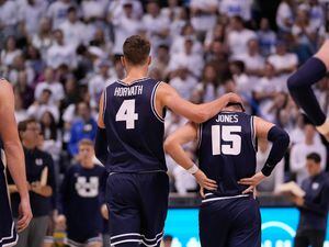 (Francisco Kjolseth | The Salt Lake Tribune) IUtah State Aggies forward Brandon Horvath (4) comforts Utah State Aggies guard Rylan Jones (15) following a missed opportunity in basketball action between the Brigham Young Cougars and the Utah State Aggies at the Marriott Center in Provo, Wednesday, Dec. 8, 2021.