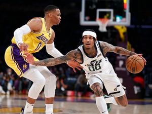 Utah Jazz guard Jordan Clarkson (00) drives past Los Angeles Lakers guard Russell Westbrook (0) during the first half of an NBA basketball game in Los Angeles, Monday, Jan. 17, 2022. (AP Photo/Ringo H.W. Chiu)