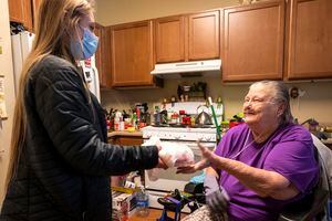 (Rick Egan | The Salt Lake Tribune) Ashley Roderick from Chefpanzee, delivers a meal to Gene Burns, at her apartment in West Jordan, on Friday, Jan. 7, 2022.