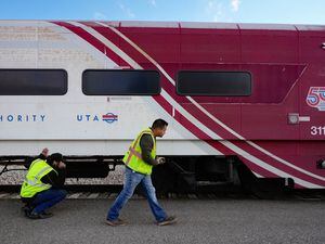(Francisco Kjolseth | The Salt Lake Tribune) Jason Giles, left, and Jason Bradshaw with Clearfield Recycling overlook a decommissioned FrontRunner Comet Car with an interest in scrapping the old train cars on Monday, Oct. 24, 2022, as they are auctioned off in order for UTA to receive new federal funding.