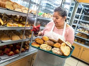 (Leah Hogsten | The Salt Lake Tribune) Panadería Flores owner Concepcion Flores holds a tray of customer favorites. Panadería Flores, a Mexican bakery in Rose Park, serves an international community with fresh bread daily as well as bolillos, conchas and cookies, Nov. 23, 2021.