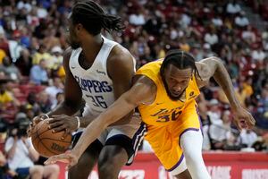 (John Locher  |  AP file photo) Paris Bass, right, playing for the Lakers' summer league team against the Clippers' Jarrell Brantley on Tuesday, July 12, 2022, in Las Vegas. Bass agreed to a one-year contract with the Utah Jazz on August 7, 2022.