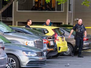 (Rick Egan | The Salt Lake Tribune) Salt Lake City Police look through car windows as they investigate a shooting at the Pebble Creek Apartments on 1700 South, where on person was killed and three were injured, on Monday, June 6, 2022.