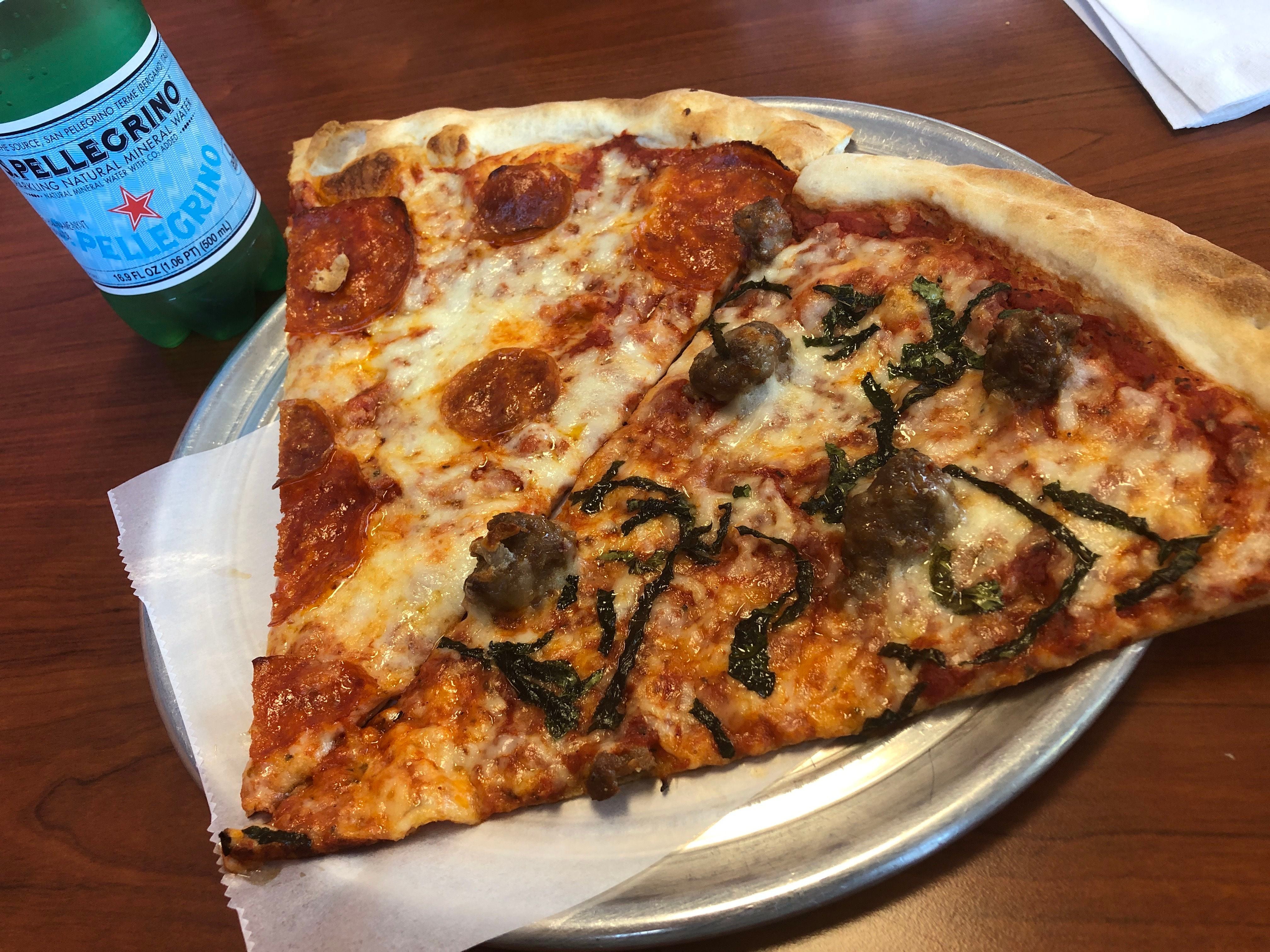 (Kolbie Peterson | The Salt Lake Tribune) Two slices of pizza from Villaggio Pizzeria are shown, one pepperoni and one sausage and basil, on Saturday, April 13, 2024.