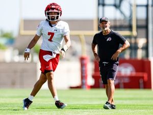(Hunter Dyke | Utah Athletics) Utah Utes Football opened its 2022 fall camp on Wednesday. Quarterback Cam Rising, left, and head coach Kyle Whittingham, right, have high hopes for the Utes this season.