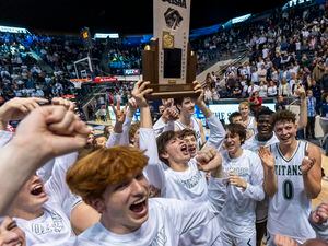 (Rick Egan | The Salt Lake Tribune) the Olympus titans celebrate their win in the 5A State Championship game between Woods Cross and Olympus, at the Marriott Center in Provo, on Saturday, March 5, 2022. 