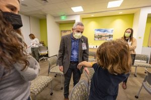 (Melissa Majchrzak | Primary Children’s Hospital) Dr. Andrew Pavia, a pediatric epidemiologist at Primary Children’s Hospital, examines where a child received a COVID-19 vaccination on Nov. 5, 2021. Salt Lake Tribune readers selected his as Utahn of the Year for 2021 in an unscientific survey.
