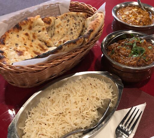 (Kolbie Peterson | The Salt Lake Tribune) Onion kulcha bread, top left, and lamb rogan josh, middle right, from Bhansa Ghar, a new Indian/Nepali restaurant at 250 W. 2100 South, Salt Lake City.
