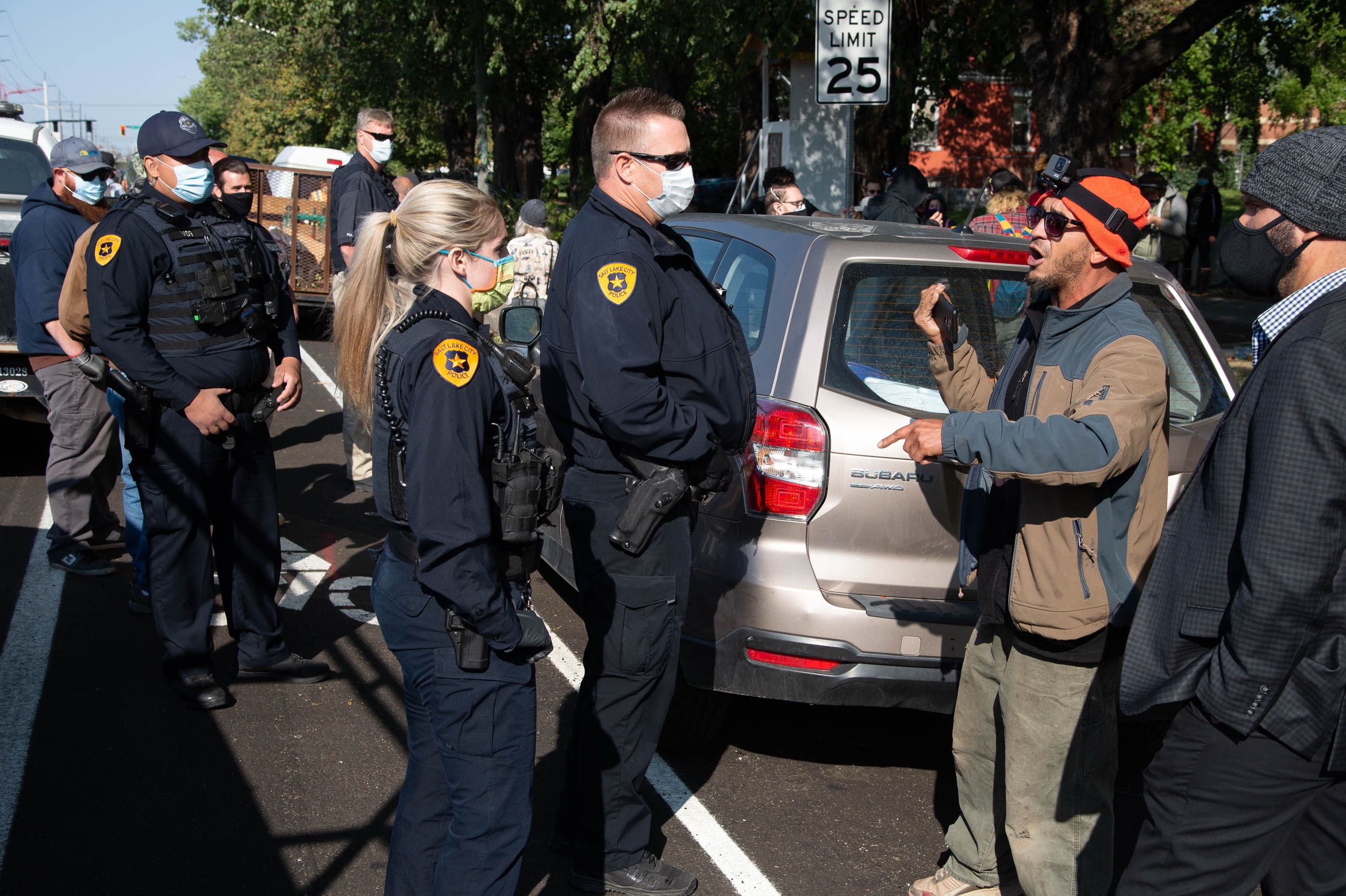 (Francisco Kjolseth  |  The Salt Lake Tribune) Police are confronted by homeless advocates as the Salt Lake County Health Department conducts a cleanup of homeless camps set up near Taufer Park in Salt Lake City on Thursday, Sept. 10, 2020. 