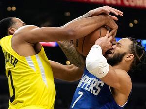 Utah Jazz guard Talen Horton-Tucker, left, blocks the shot of Los Angeles Clippers guard Amir Coffey during the second half of an NBA basketball game Monday, Nov. 21, 2022, in Los Angeles. (AP Photo/Mark J. Terrill)