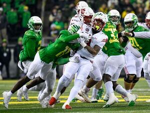 (Andy Nelson | AP) Utah running back Ja'Quinden Jackson is tackled by Oregon defensive back Trikweze Bridges (11) during the first half of an NCAA college football game Saturday, Nov. 19, 2022, in Eugene, Ore.