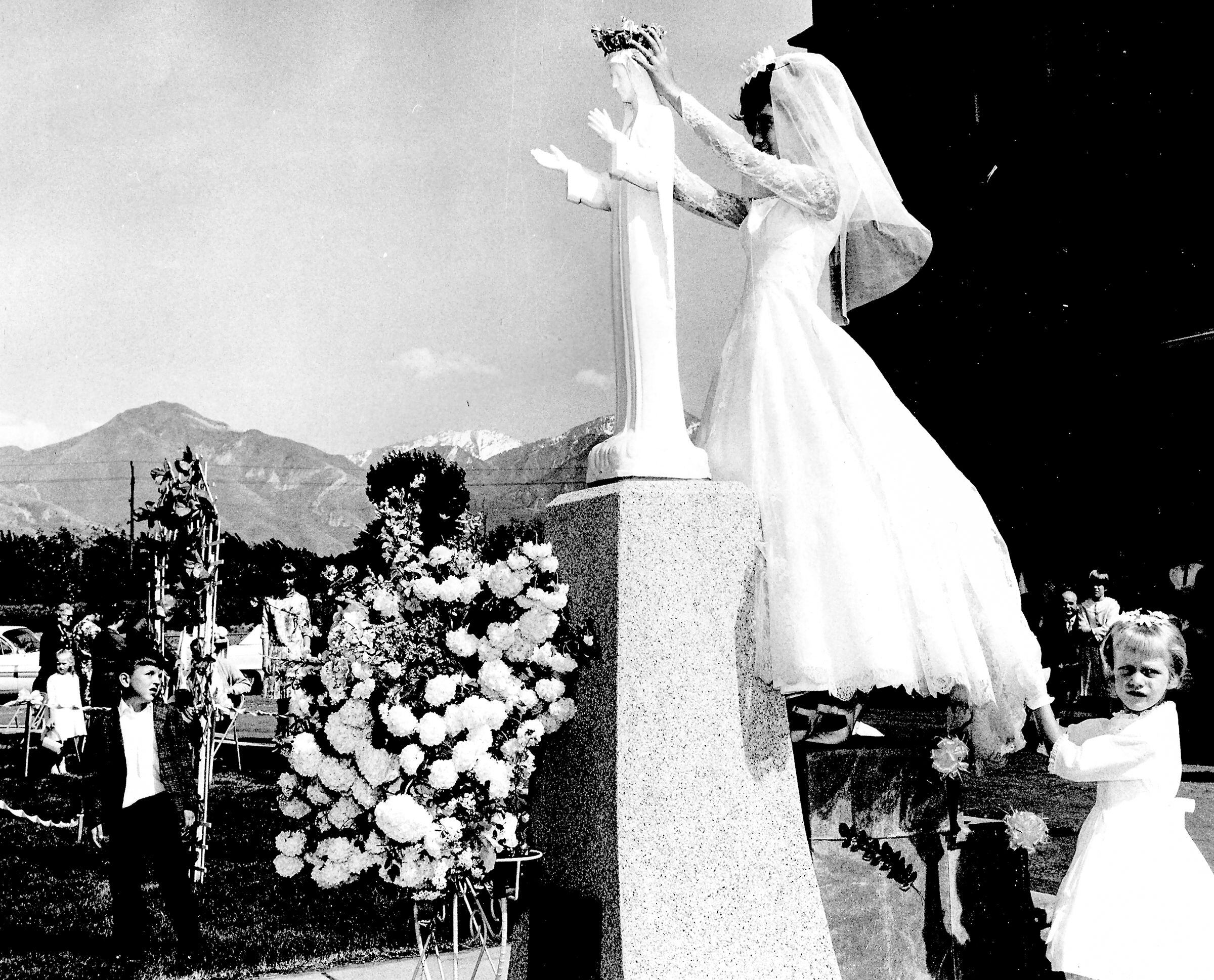 (Roman Catholic Diocese of Salt Lake City archives) At a 1966 spring celebration to honor the Virgin Mary, a student from St. Ann Parish wears an elaborate wedding dress — evoking both her First Communion and her future marriage.