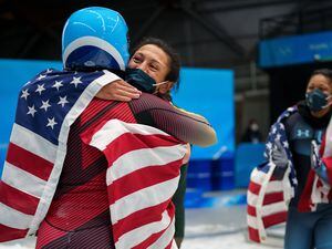 (Trent Nelson  |  The Salt Lake Tribune) Bronze medalist Elana Meyers Taylor, center, embraces German gold medalist Deborah Levi after the 2-woman bobsled at the 2022 Winter Olympics in the Yanqing district of Beijing on Saturday, Feb. 19, 2022. At right is Sylvia Hoffman.