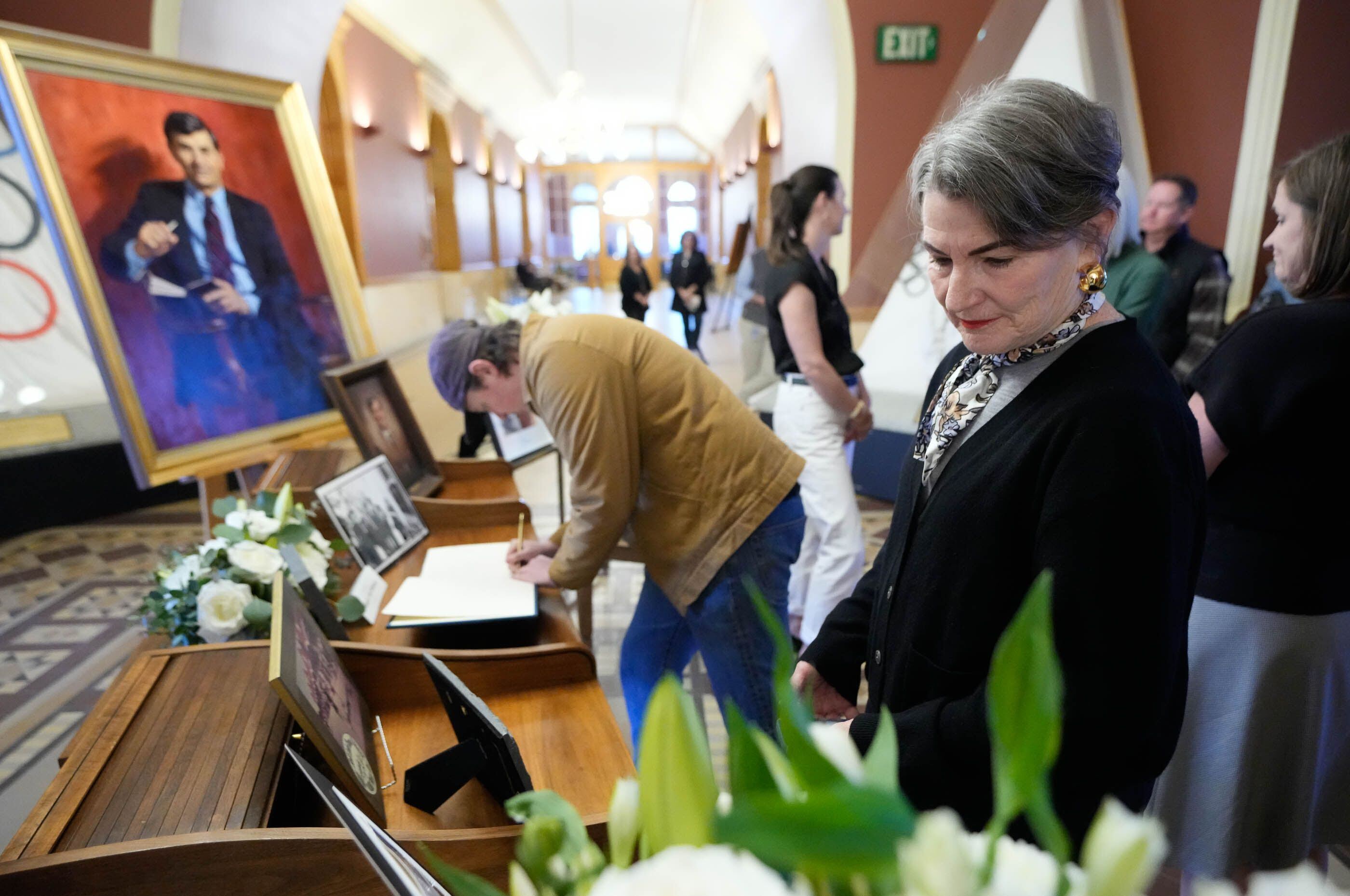 (Francisco Kjolseth | The Salt Lake Tribune) Holly Mullen, widow of former Salt Lake City Mayor Ted Wilson, looks at photographs on display at Salt Lake City Hall on Monday, April 15, 2024.