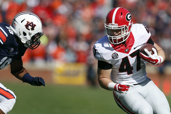 FILE - In this Nov. 14, 2015, file photo, Georgia fullback Christian Payne (47) carries the ball as Auburn defensive back Carlton Davis (18) closes in for a tackle during during the first quarter of an NCAA football game in Auburn, Ala. No. 2 Oklahoma and No. 3 Georgia meet for the first time Monday, Jan. 1, 2018, at the Rose Bowl in a College Football Playoff semifinal that features two very different ways of playing offense. (AP Photo/Butch Dill, File)