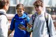(Bethany Baker  |  The Salt Lake Tribune) Students look at their cellphones after school as they leave Granite School District's Evergreen Junior High School on Tuesday, April 16, 2024. The district is considering implementing a universal policy banning cellphone use during school.