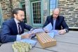 (Nathan Oman) Rabbi Itamar Rosensweig, left, and Latter-day Saint contract lawyer Nathan Oman review an agreement to sign over to Oman the title to Jewish families' leavened goods during Passover. Oman paid for these items using the silver dollars pictured and gifted to him by the rabbi.